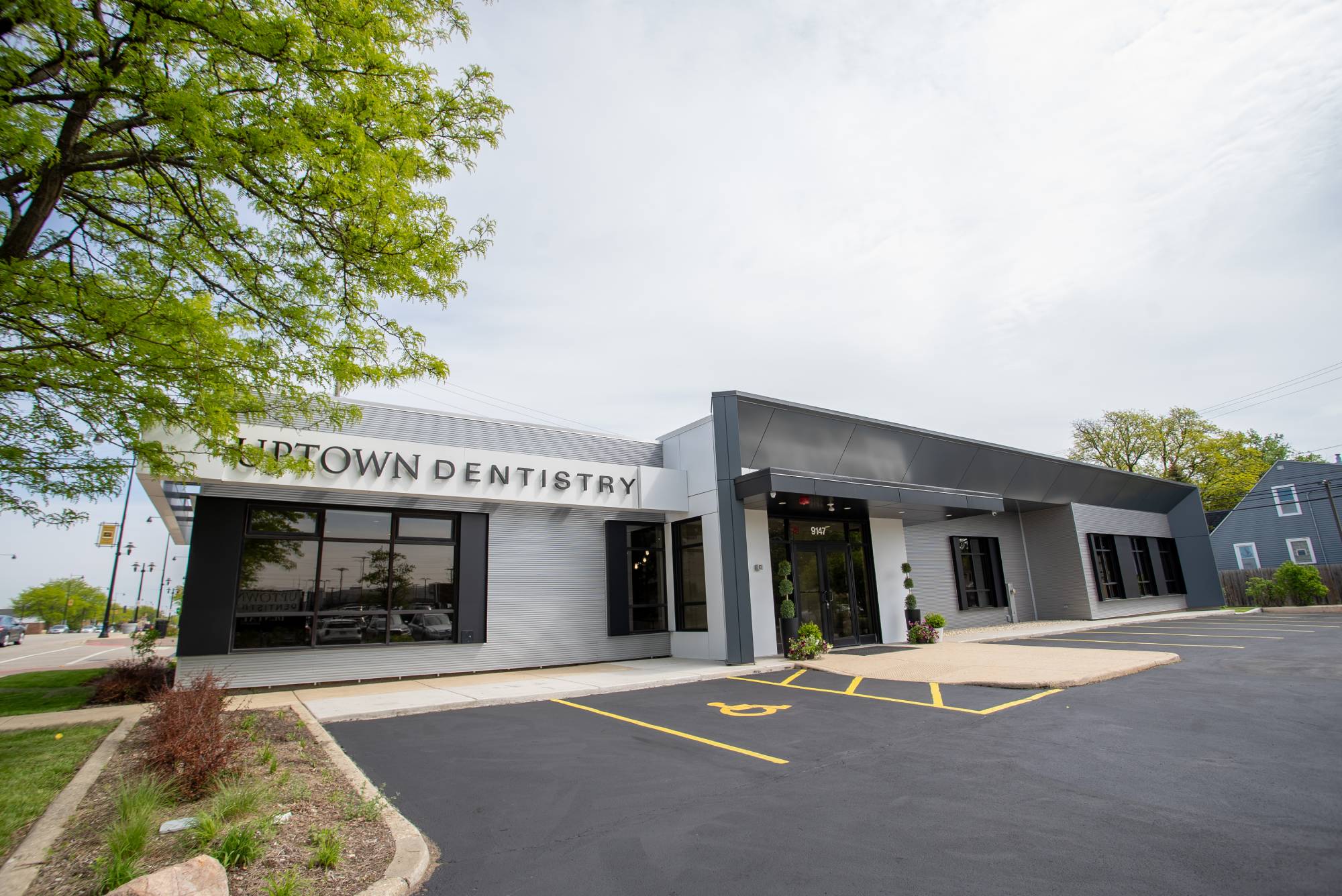 Happy patient booking an appointment Uptown-Dentistry-Office